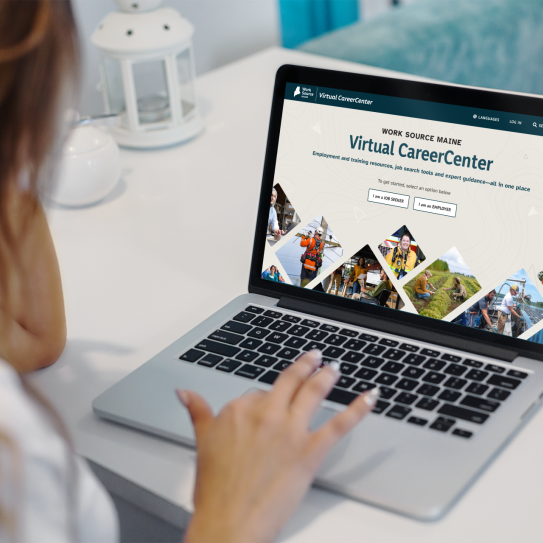 Person using laptop to view Work Source Maine Virtual CareerCenter homepage with job seeker and employer options