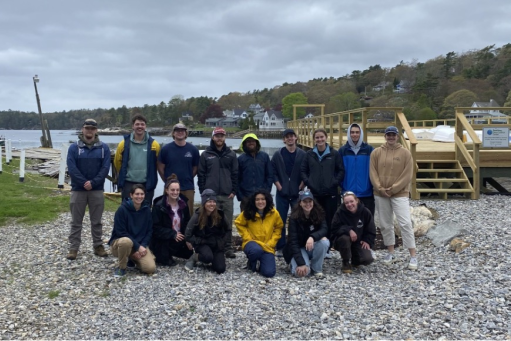 Group of people posing on a marina