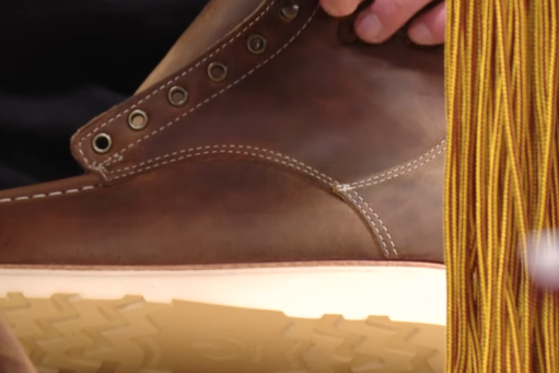 A close up on someone making a brown boot
