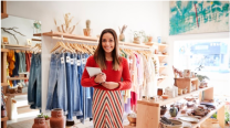 A woman in a red dress standing in a retail store